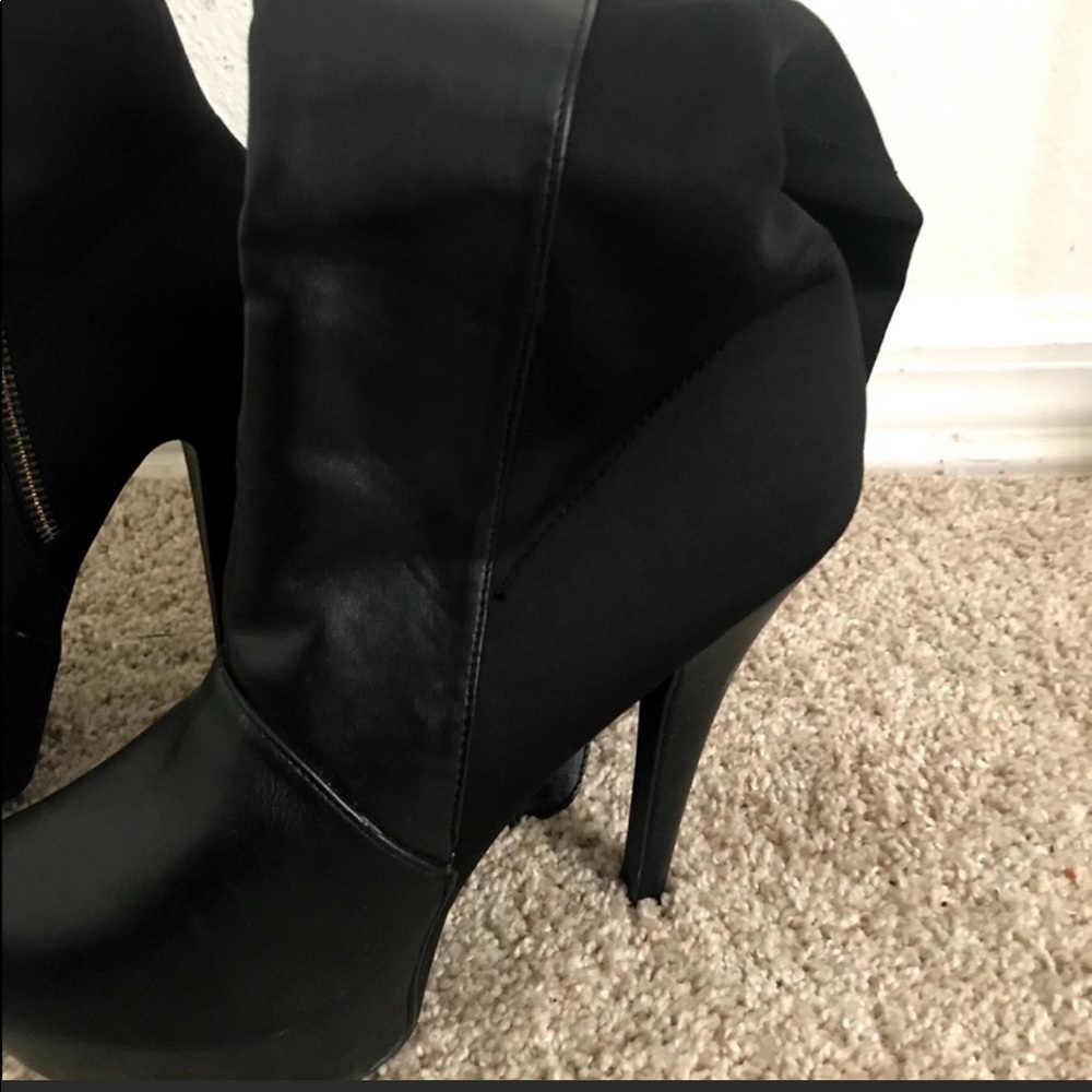 Thigh high black leather boots